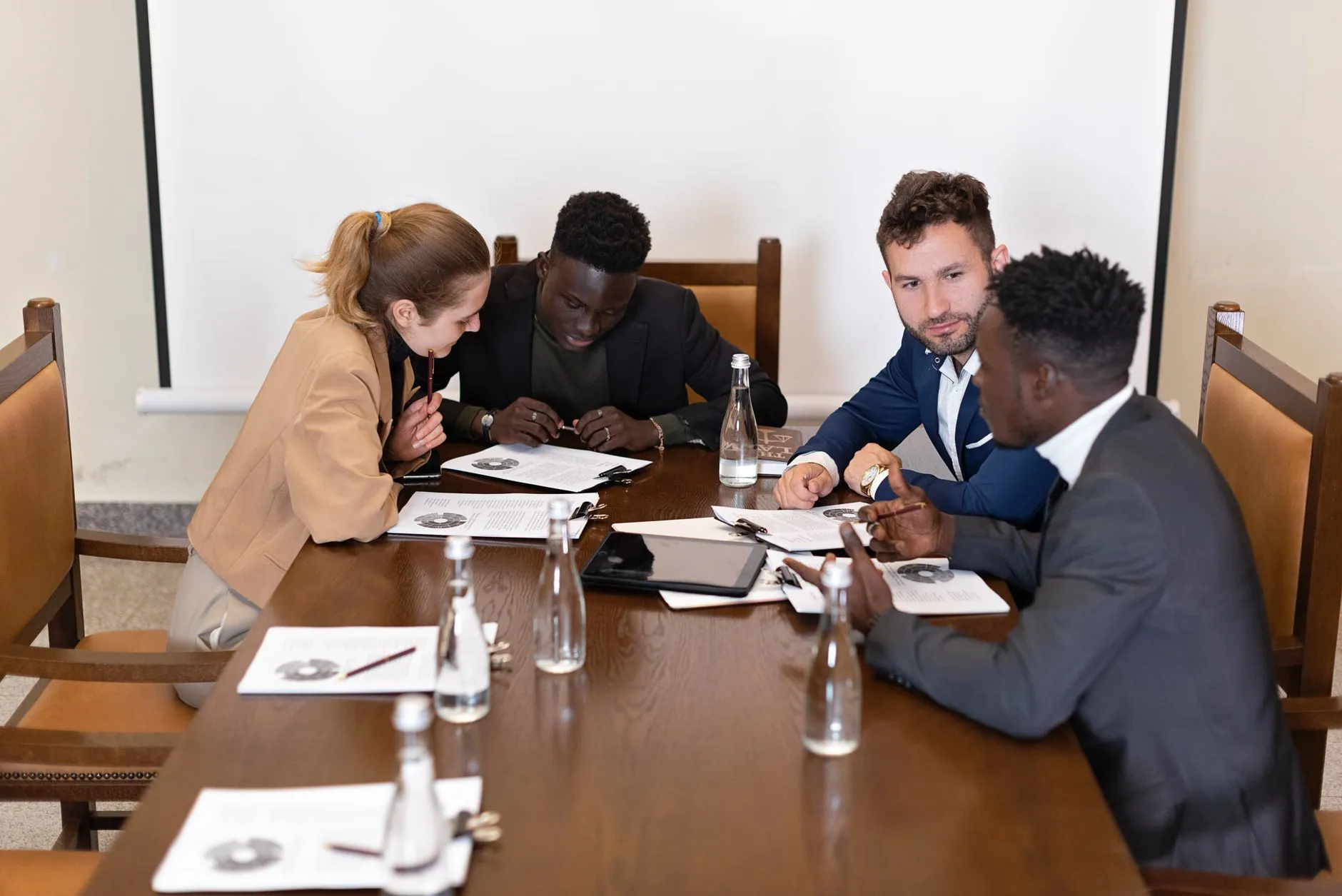 A team working through documents around a conference table